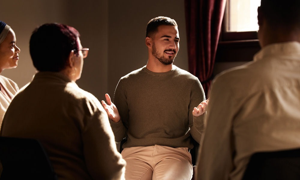 recovery group meeting with man addressing group