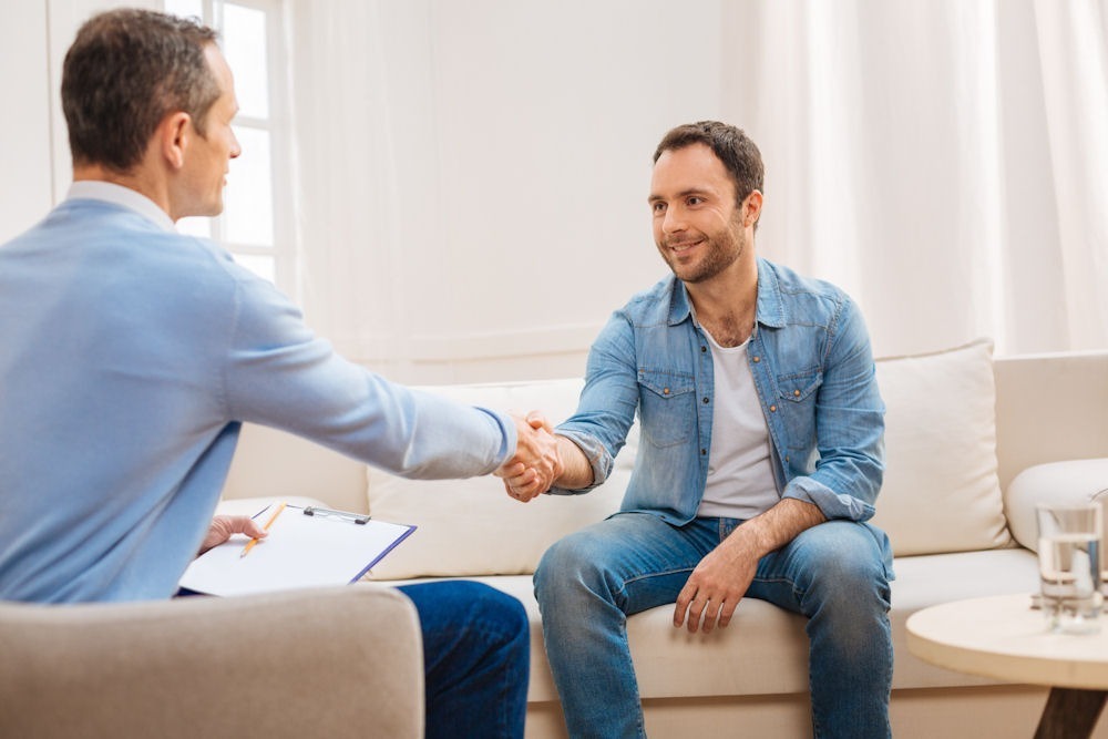 man shaking hands with counselor