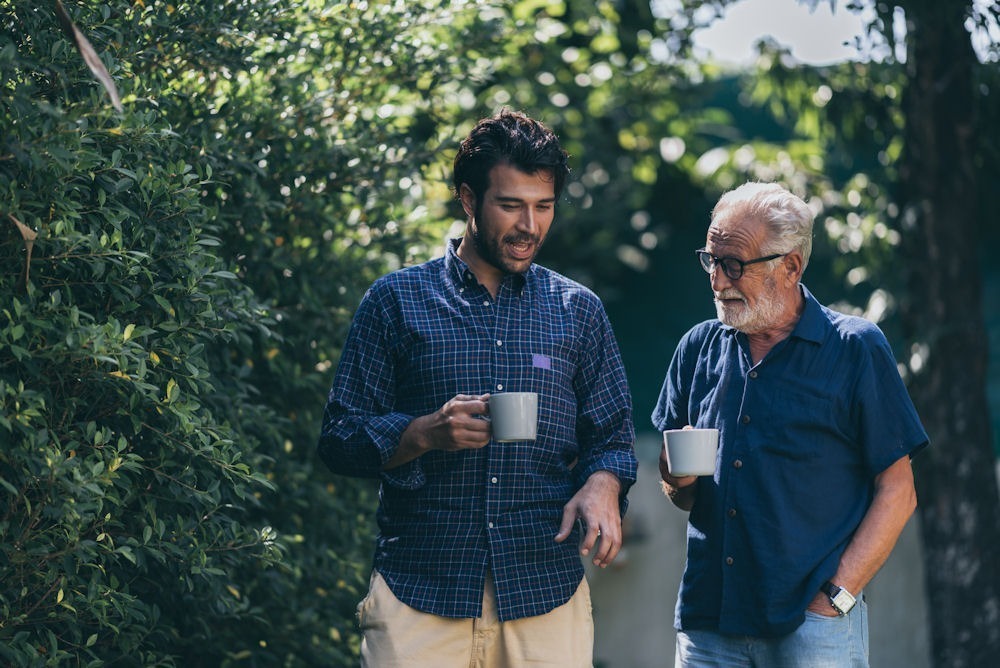 men walking outside with coffee mug