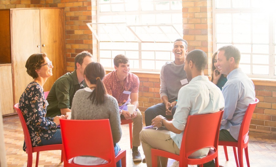 group of diverse individual sitting in group meeting