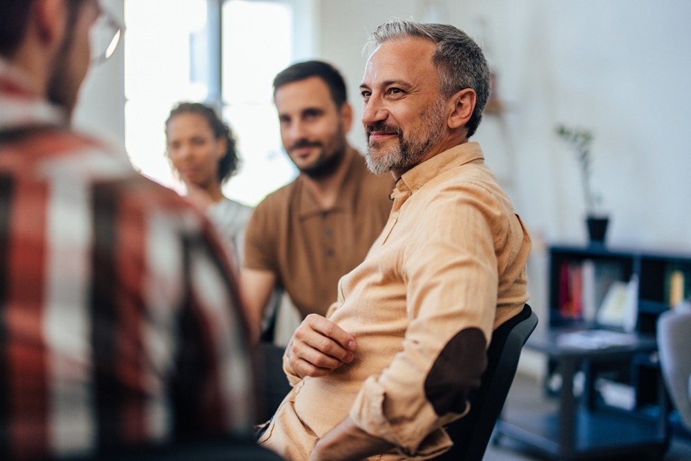 men in recovery group meeting