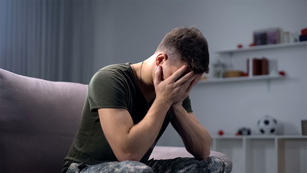 a-veteran-with-his-face-in-his-hands-with-ptsd